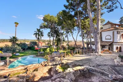 a home with a swimming pool and a house at Villa near Valencia 17PAX, Pool, Cinema, BBQ, KidsRoom in Manises