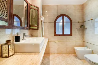 a bathroom with a sink and a toilet at Villa near Valencia 17PAX, Pool, Cinema, BBQ, KidsRoom in Manises