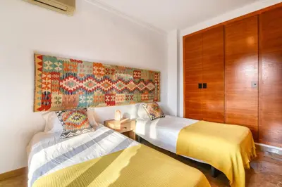 a bedroom with two beds and a painting on the wall at Villa near Valencia 17PAX, Pool, Cinema, BBQ, KidsRoom in Manises