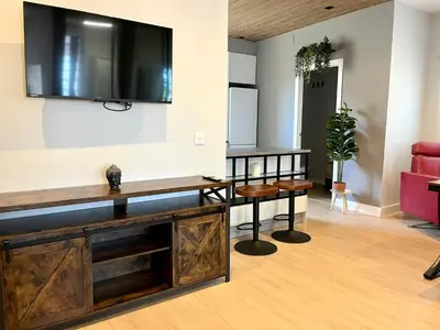 a living room with a tv on the wall at Encantador apartamento boutique a 5 min del metro in Bétera