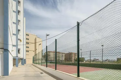 a tennis court with a net on a tennis court at Fantastic beach apartment near Valencia in Valencia