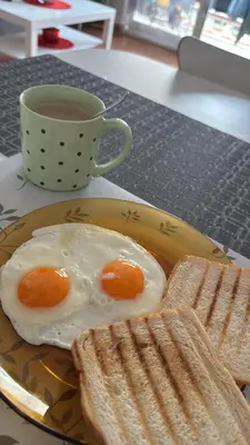 a plate with two eggs and toast and a cup of coffee at Hogar Mediterráneo in Valencia