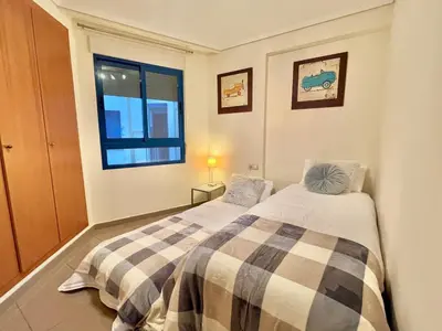 a bedroom with two beds and a window at Complejo de playa in Valencia