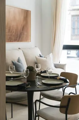 a living room with a table and a couch at FLORIT FLATS - Estudio de Diseño en el Corazón de Ruzafa in Valencia
