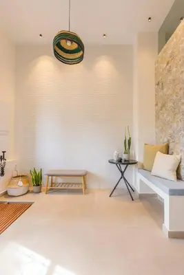 a living room with a bench and a table at SeaFront Casa Valencia in Valencia