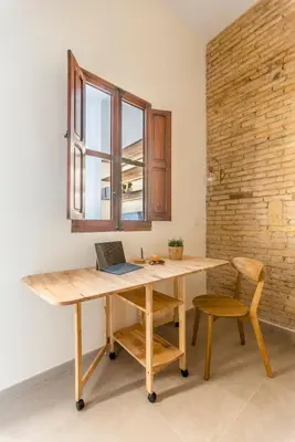 a wooden desk with a laptop on it in a room at SeaFront Casa Valencia in Valencia