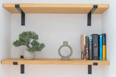 a wooden shelf with a plant and books at VLC HOST - Oriente in Valencia