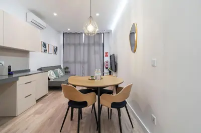 a kitchen and dining room with a table and chairs at VLC HOST - Oriente in Valencia