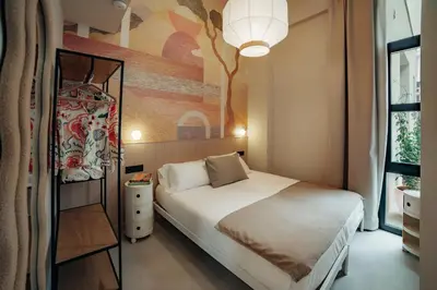 a bedroom with a bed and a painting on the wall at The Atelier Lofts in Valencia
