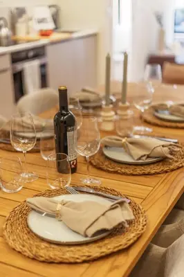 a wooden table with glasses and a bottle of wine at SariStays Valencia Luxe Touch in Valencia