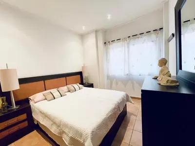 a bedroom with a bed and a doll sitting on a dresser at Planta baja en pleno centro de la playa in Moncófar