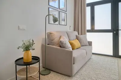 a living room with a couch and a table at Romantic Suite Roig Arena N4 Virkin Suites in Valencia