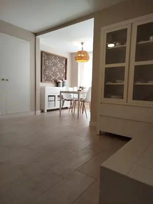 a living room with a table and a dining room at Cullera Playa de los Olivos Apartment in Faro de Cullera