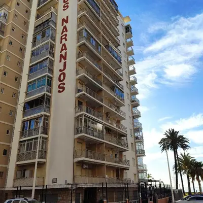 a large apartment building with a sign on it at Apartamento primera línea Cullera in Cullera