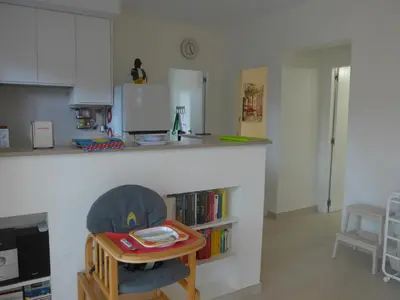 a kitchen with a table and a chair in a room at Casa Kiosko 1 bedroom ground floor with swimming pool in La Eliana