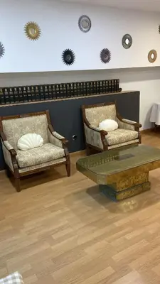 two chairs and a coffee table in a room at Hostal Casa Sifre in Villanueva de Castellón