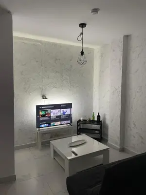 a living room with a couch and a tv at A vacation by the sea in Puerto de Sagunto