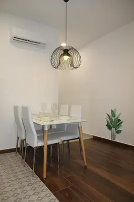 a dining room with a white table and chairs at A Malilla&Ruzafa in Valencia