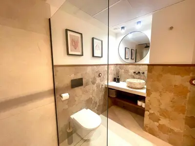 a bathroom with a toilet and a sink and a mirror at Pepitos House in Valencia