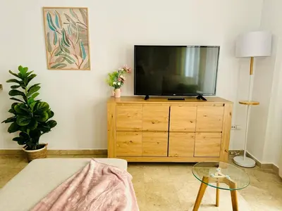 a living room with a television on a wooden dresser at ABAT 1 Cool & Wide Flat next to the Cathedral in Valencia