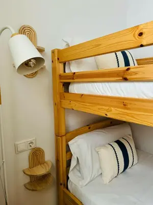two bunk beds in a room with a lamp at ABAT 1 Cool & Wide Flat next to the Cathedral in Valencia