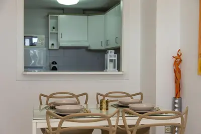 a dining room with a glass table and chairs at Beachfront apartment Cullera Espacio in Cullera