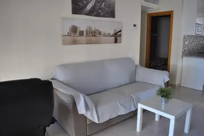 a living room with a couch and a table at RelaxUp Apartment Patacona Beach in Valencia
