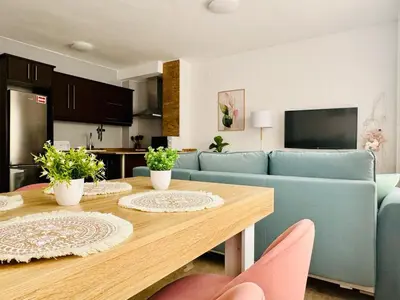a living room with a table and a blue couch at ABAT 2 Cool & Wide Flat next to the Cathedral in Valencia
