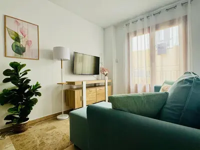 a living room with a blue couch and a television at ABAT 2 Cool & Wide Flat next to the Cathedral in Valencia