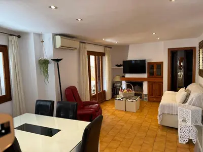a living room with a table and chairs at Puebla de Farnals playa- Oasis Apartments - Costa de Valencia Beachside Stay in Puebla de Farnals