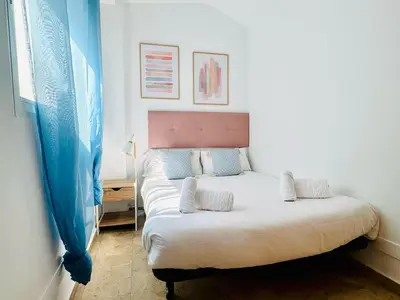 a bedroom with a large bed with two pillows at ABAT 3 Cool & Wide Duplex Next to the Cathedral in Valencia