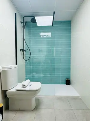 a bathroom with a toilet and a glass shower at ABAT 4 Cool & Wide Studio in the Historic Center in Valencia