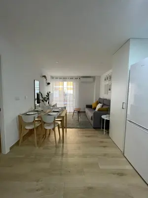 a kitchen and living room with a table and a refrigerator at Where You Feel Home in Godella