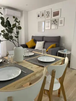 a dining room table with two white plates on it at Where You Feel Home in Godella