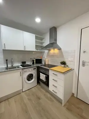 a kitchen with a washing machine and a sink at Where You Feel Home in Godella