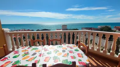 a table on a balcony with a view of the ocean at Playa Paradis III - Primera linea de playa in Moncófar