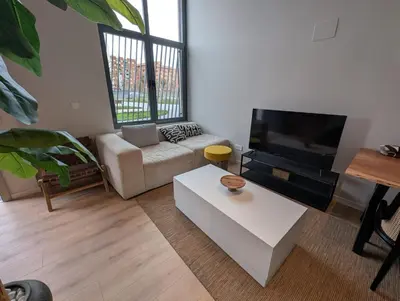 a living room with a couch and a tv at City of Arts Valencia Flats by Rent Me in Valencia