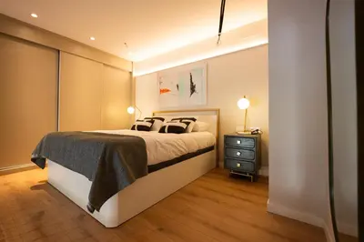 a bedroom with a large bed and a night stand at City of Arts Valencia Flats by Rent Me in Valencia