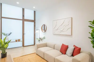 a living room with a couch with red pillows at Flats poeta serrano in Valencia
