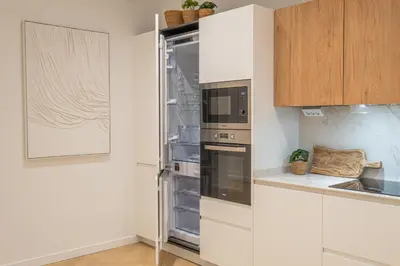 a kitchen with an empty refrigerator and a microwave at Flats poeta serrano in Valencia