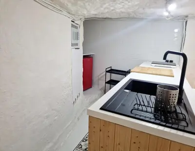 a small kitchen with a stove and a sink at casa cueva a 15 minutos del centro de Valencia in Paterna
