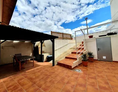 a patio with a bench and stairs on a building at casa cueva a 15 minutos del centro de Valencia in Paterna