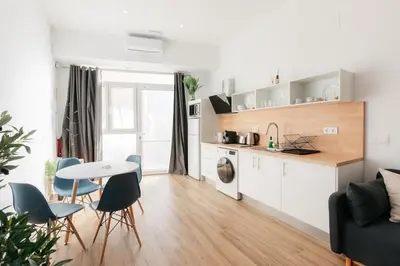 a kitchen and living room with a table and chairs at Stylish Studio with Easy Access to Valencias Best in Valencia