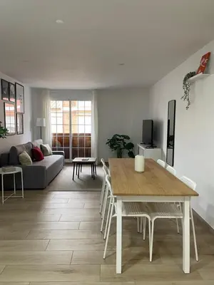 a living room with a table and a couch at Little Rose apartment in Godella