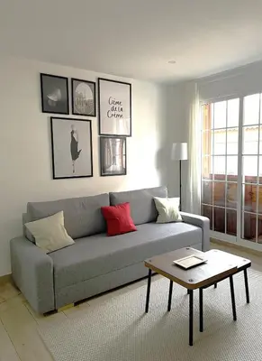 a living room with a couch and a table at Little Rose apartment in Godella