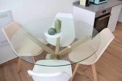 a glass table with two white chairs and a cactus at Ruzafa Alegria in Valencia