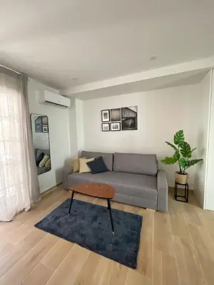 a living room with a couch and a table at Cute little apartment in Godella