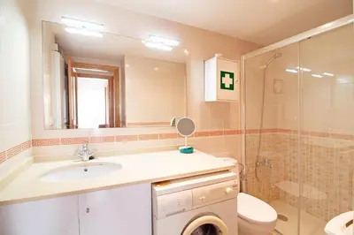 a bathroom with a sink and a toilet and a shower at Global Vacacional, Ático con barbacoa y gran terraza in Canet de Berenguer