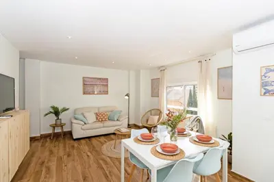 a living room with a white table and chairs at GuestReady - Your Sunny Valencia Basecamp in Valencia