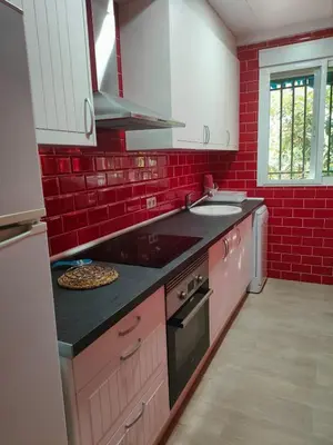 a kitchen with red brick walls and a counter top at Brisas del Lago in Navarrés